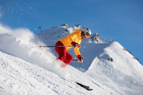 A beginner skiing on powdery snow. 